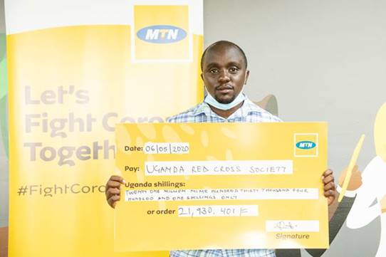 A Red cross Official Displays the Cheque containing the donation by MTN customers to fight Covid19